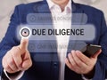 DUE DILIGENCE text in menu. Businessman looking for something at cellphone. Due diligenceÃÂ is an investigation, audit, or review